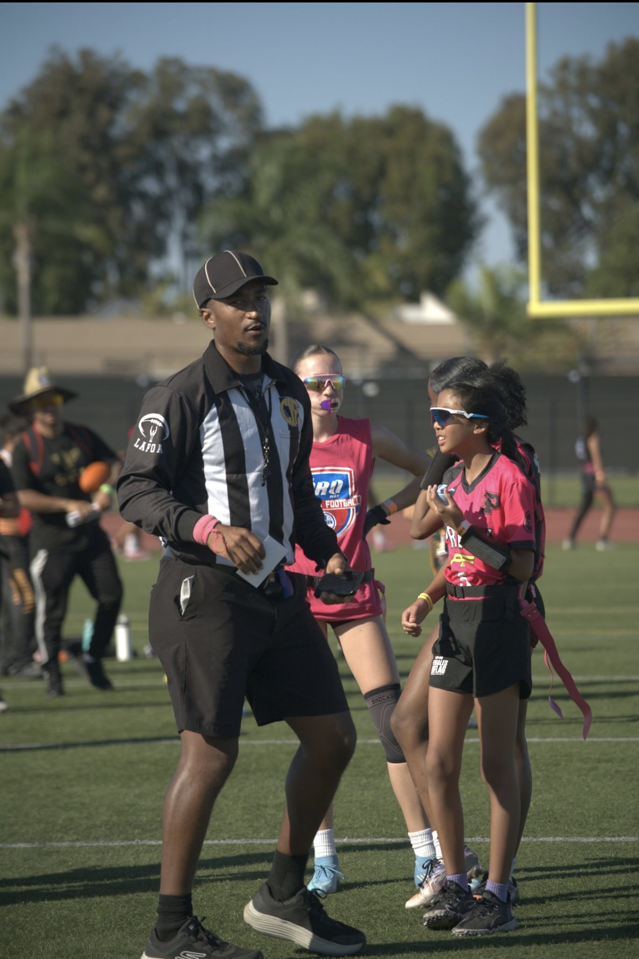 Proway coach speaking with a player during game action