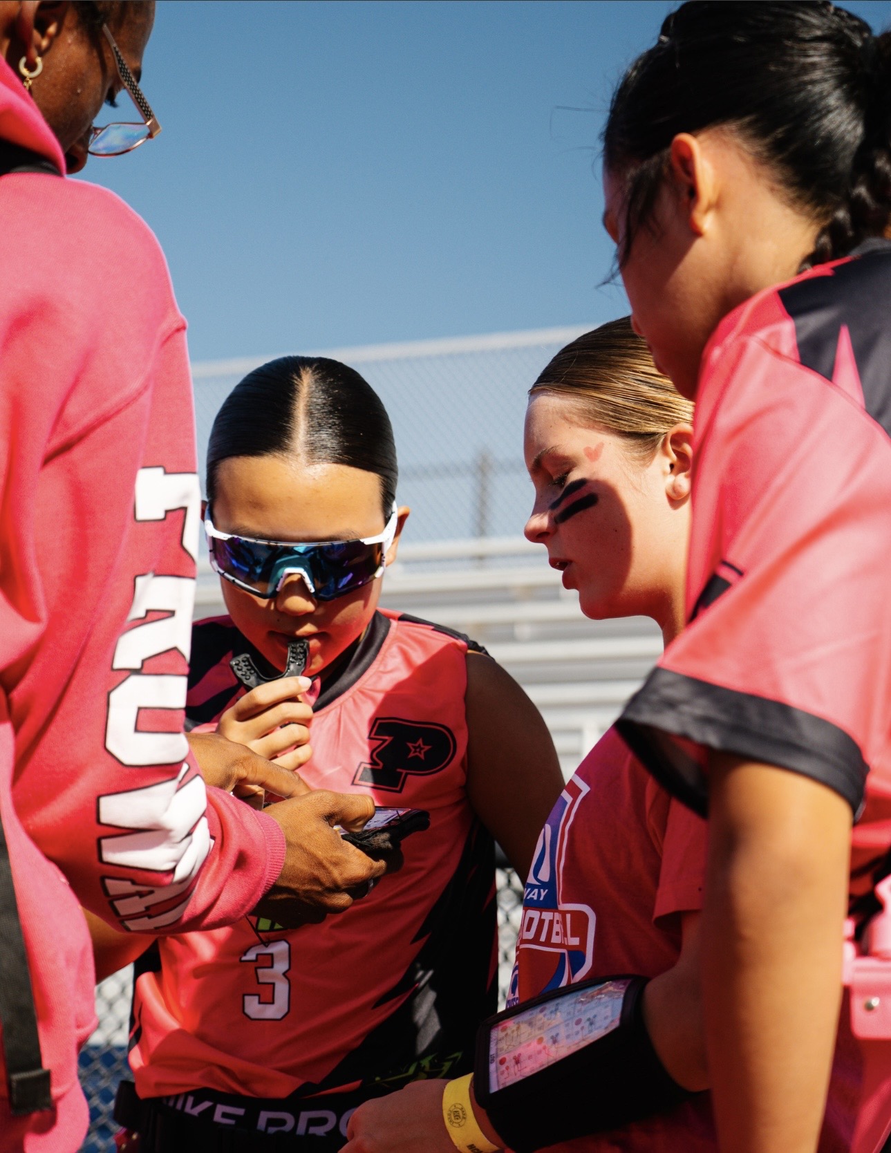 Proway coach helping players prepare together on the sideline